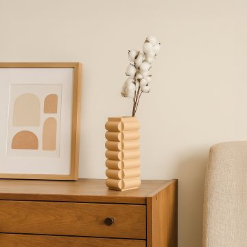 A modern beige geometric vase displayed in a minimal setting adding a warm sculptural touch to contemporary home styling and decor.