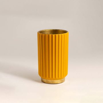 Bright yellow metal vase with ribbed texture and shiny gold base illuminated against a white background for a contemporary look.