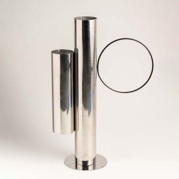 Contemporary silver vase displayed on a white background highlighting its glossy metallic finish and artistic tubular form.