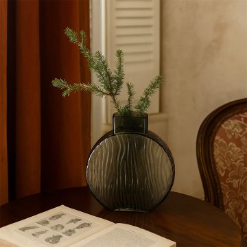 Round smoky gray glass vase with artistic wavy texture styled beautifully in a modern home interior for a refined touch.