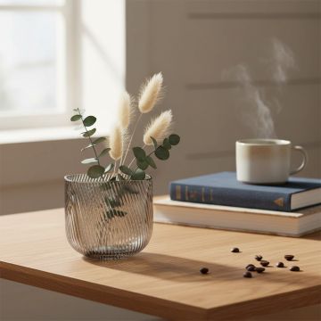 Smoky gray ribbed glass vase styled elegantly in a modern living space adding a touch of sophistication and charm.
