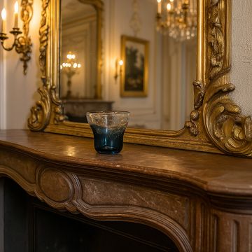Blue bubble glass vase styled on a wooden table adding a touch of coastal charm to modern interiors.