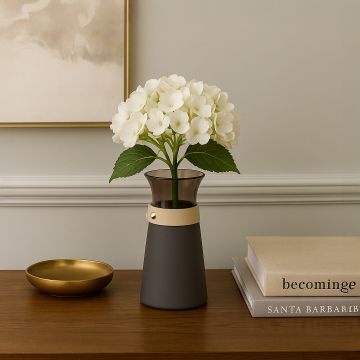 Two-tone glass and matte black vase with flared top and beige accent band displayed on a white background.