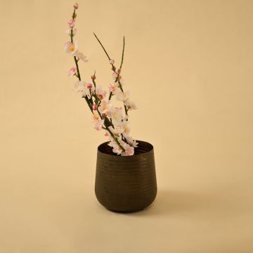 Brown metal planter decor styled in a warm modern room adding earthy charm to living room tables and console accents.