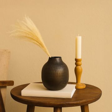 Brown hammered metal vase decor styled in a warm modern room adding rustic elegance to living room consoles and tables.