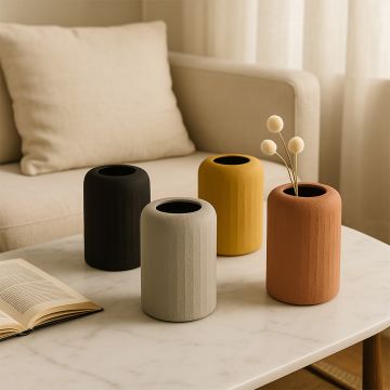 Black textured ceramic vase styled with other decor pieces creating a modern moody look for elegant home styling.