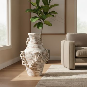 Tall chain vase placed beside a beige sofa and indoor plant in a cozy sunlit modern living room.