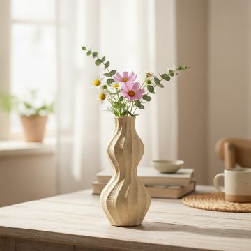 Textured wavy vase placed on a wooden table with pink and white flowers in a bright sunlit room for natural home styling.