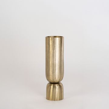 Gold metal vase with vertical ribbed surface and round base displayed clearly against plain white background wall