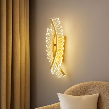 Gold decorative wall light with sculpted acrylic design adding warm ambient lighting to a modern elegant interior.