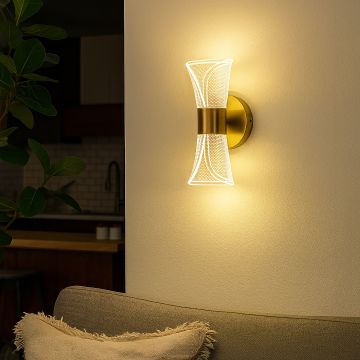 Gold wall light with sculpted clear glass shade adding warm ambient lighting to a modern elegant interior.