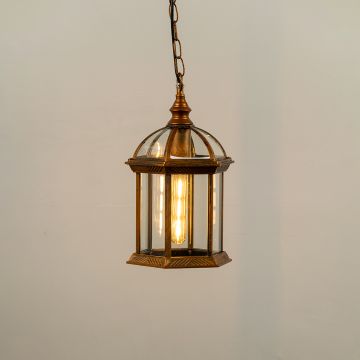 Bronze hanging outdoor lantern on white background with light on displaying warm illumination through clear glass panels and vintage dome top design.