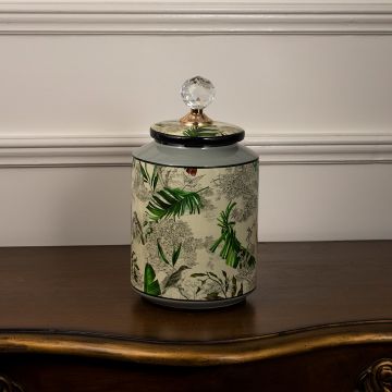 Tropical bird jar with crystal lid featuring hand-drawn bird illustration and lush tropical leaf patterns.