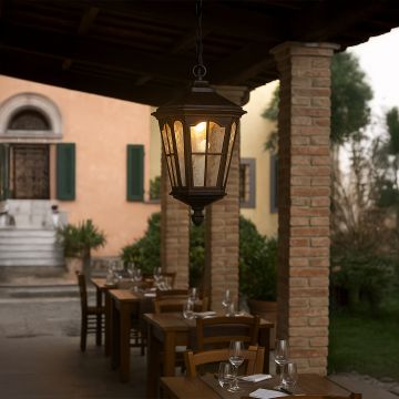 Outdoor hanging lantern light illuminating a rustic patio setting adding vintage charm and warm ambient lighting for outdoor dining and garden spaces.