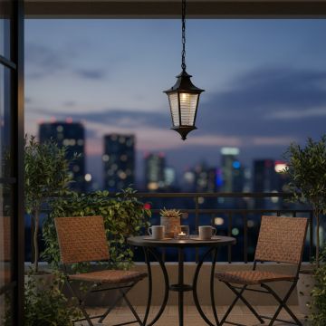 Elegant black metal hanging lantern with ribbed glass glowing warmly for outdoor garden and balcony lighting decor.