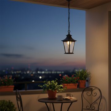 Elegant black metal hanging lantern with clear glass panels for outdoor home lighting shown in a clean lifestyle setting.