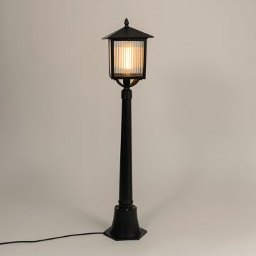 A classic outdoor lamp post with the light on against a clean white background highlighting its warm glow and refined lantern frame for clear product visibility.