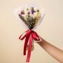 Elegant dried flower bouquet with infinity rose purple sunflower white and fern leaves tied with red satin ribbon.
