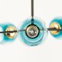 Close view of blue glass chandelier showing detailed craftsmanship golden joints and premium textured glass design with elegance.