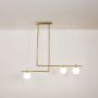 Contemporary gold pendant light with three bright glass globes displayed on clean white background for ceiling lighting.