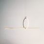 Black linear pendant light illuminated on a clean white background highlighting its sleek modern form.