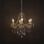 Elegant chandelier with golden crystal finish illuminated against black background for luxury home lighting.