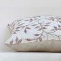 White cotton cushion cover with brown and grey embroidered botanical patterns adding artisan charm to home décor with a soft smooth and skin friendly material finish.