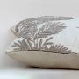Soft cotton cushion cover with beige botanical embroidery shown at an angle providing an elegant nature inspired décor element with a breathable gentle and skin friendly material texture.
