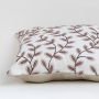 Closeup of cotton cushion embroidery showing detailed brown leaf stitching and soft fabric texture ideal for warm and elegant home decor styling.