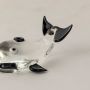 Detailed closeup of transparent glass dolphin figurine with glossy black fins showing smooth handmade finish.