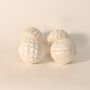 Single decorative carved ball displayed on white background showcasing handcrafted geometric texture and natural matte glaze.