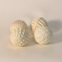 Single textured ceramic ball on white background showcasing handmade carved pattern and artisan craftsmanship.