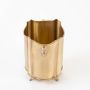 Open top view of tall brass container with scalloped rim and engraved design placed on plain white background.