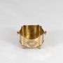 A finely crafted brass champagne bucket with ornate legs shown against a white background highlighting its smooth finish and decorative detailing.