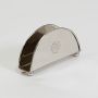 Classic semi circular silver napkin holder with ball feet and engraved logo standing empty against a clean white background.
