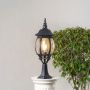 Elegant outdoor black pillar light glowing warmly with clear rounded glass panels perfect for patio driveway and terrace.