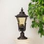 Classic black outdoor pillar lamp with decorative glass shade placed on stone base ideal for villa garden and balcony.