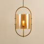 Pendant lamp with a golden metal frame and amber glass diffuser casting a soft inviting glow against a white background.