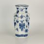 Blue and white ceramic jar with a tall angular shape covered in fine botanical patterns shown clearly creating a classic artistic accent suitable for traditional decor.