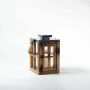 Handcrafted wooden lantern with metal top and rope handle on white background for product display.