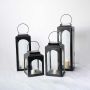Collection of black lanterns in various sizes arranged together for a cohesive home decor look.