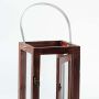 Closeup of handcrafted wooden lantern with clear glass panels and metal handle showing elegant design details.