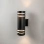 Black tall cylindrical wall light glowing on white background showcasing dual silver rings and matte finish.