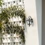 Decorative lantern wall light adding charm to a contemporary house exterior.