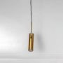 Sleek gold cylindrical pendant light with metallic finish modern ceiling lamp perfect for dining room and living room interiors.