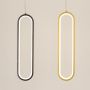Set of modern metal elongated loop hanging lights in gold displayed together for stylish wall decor arrangements.