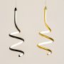 Set of modern metal spiral hanging lights in black and white displayed together for creative home decor styling.