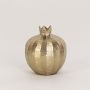 Compact gold pomegranate with hammered metal texture and crown top clearly shown on clean white background wall