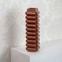 Brown ceramic designer vase with unique stacked pattern for stylish home table and shelf decoration.