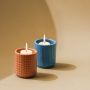 Blue ceramic textured candle holder displayed with matching decor pieces creating a modern grouped styling setup.